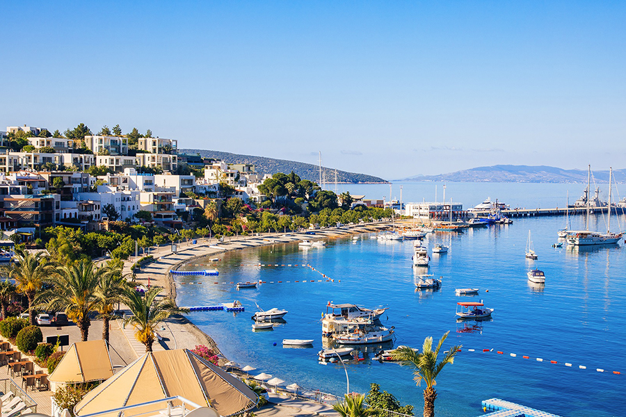 View of Bodrum Beach, Aegean sea, traditional white houses, flowers, marina, sailing boats, yachts in Bodrum town Turkey. ; Shutterstock ID 1430703236; Purchase Order: abc; Job: ; Client/Licensee: ; Other: